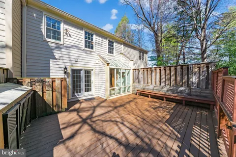 a view of backyard with deck and outdoor seating