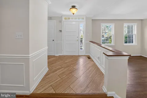 a view of a kitchen with wooden floor and staircase