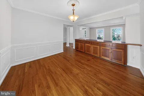 a kitchen with wooden floors and white walls