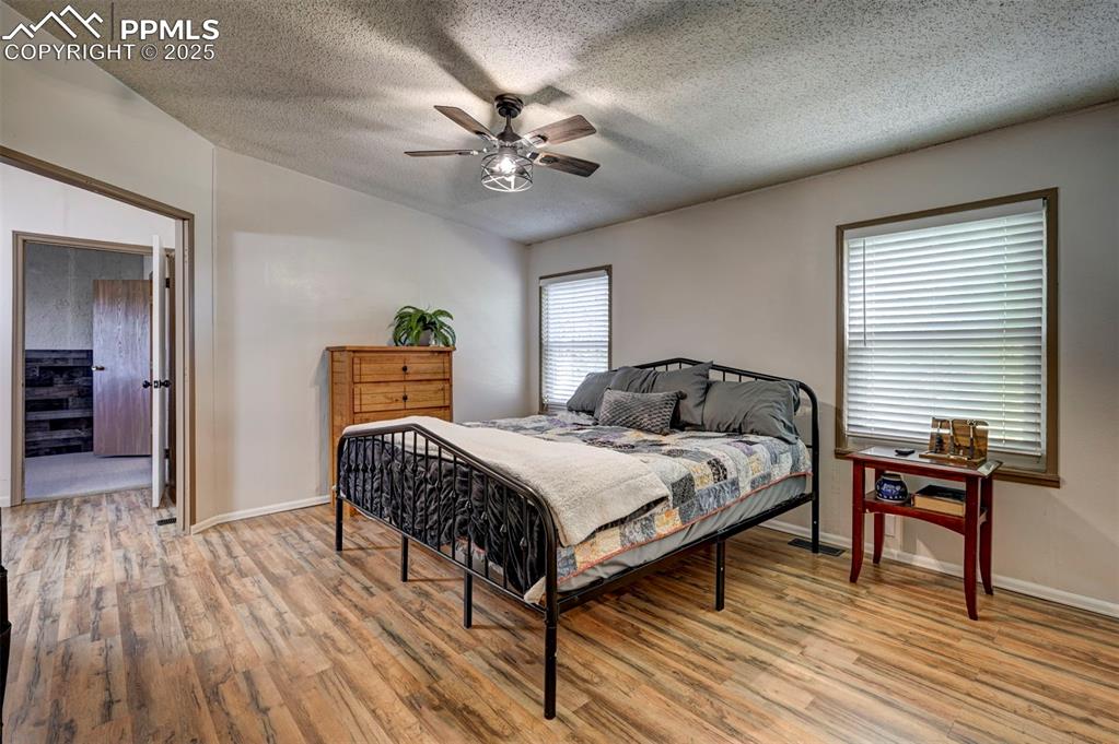 35355 Funk Road Calhan, CO 80808 - Photo 20 of 31 a bedroom with a bed and a chandelier