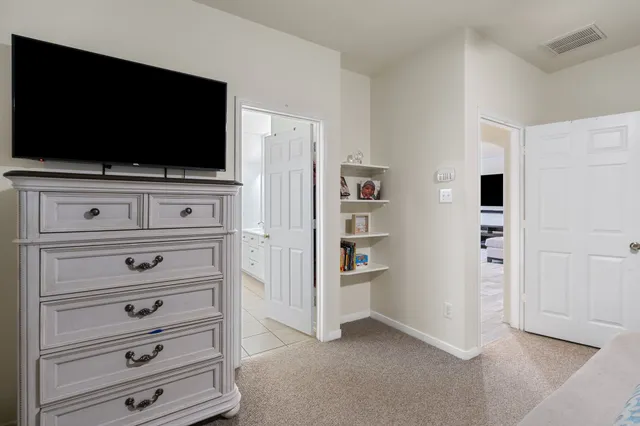 a view of flat screen tv on the dresser