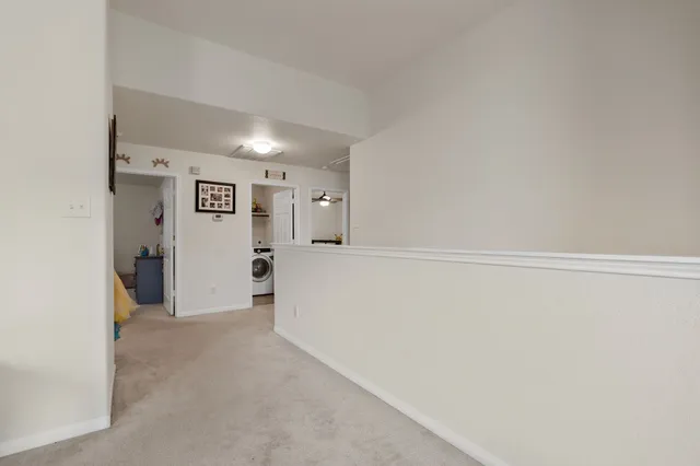 a view of backyard with small garden and wooden fence