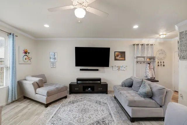 a living room with furniture and a flat screen tv