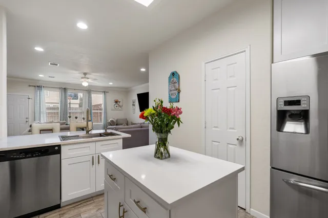 a kitchen with a sink and white cabinets