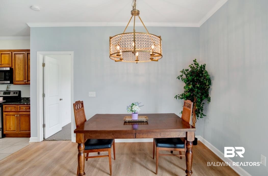 27545 Boaz Road West Loxley, AL 36551 - Photo 9 of 26 Dining room with a chandelier, light wood finished floors, and crown molding