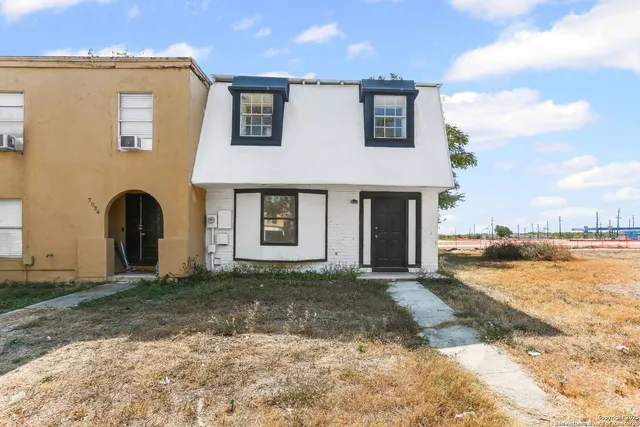 a front view of a house with a yard