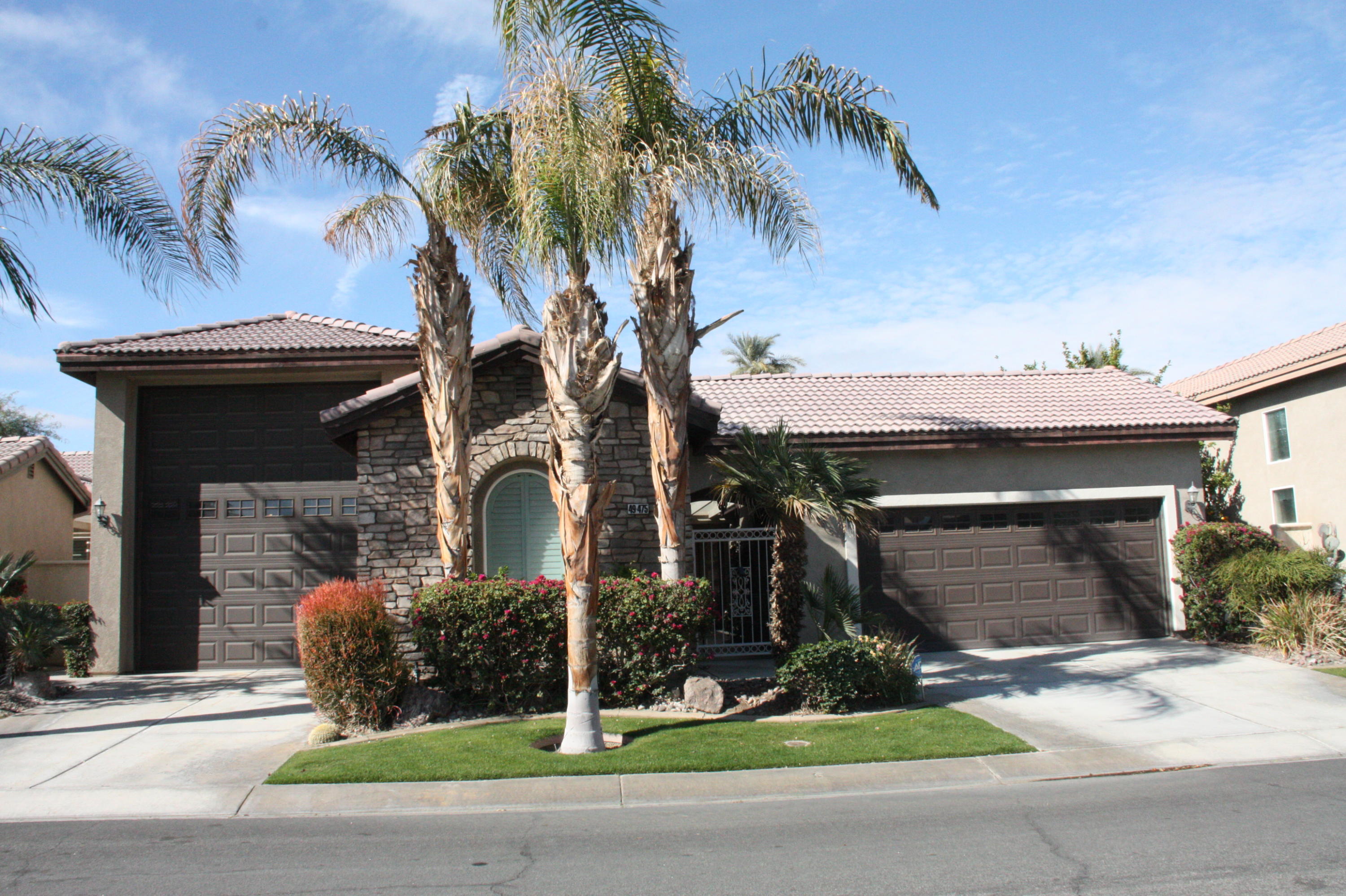 49475 Redford Way Indio, CA 92201 - Photo 1 of 58 front view of a house with a garden