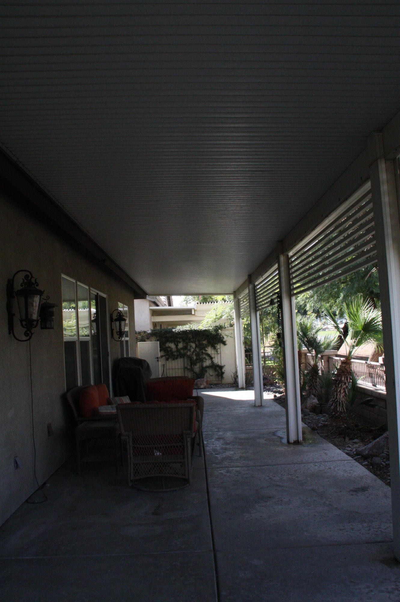 49475 Redford Way Indio, CA 92201 - Photo 13 of 58 a view of a porch with chairs and backyard