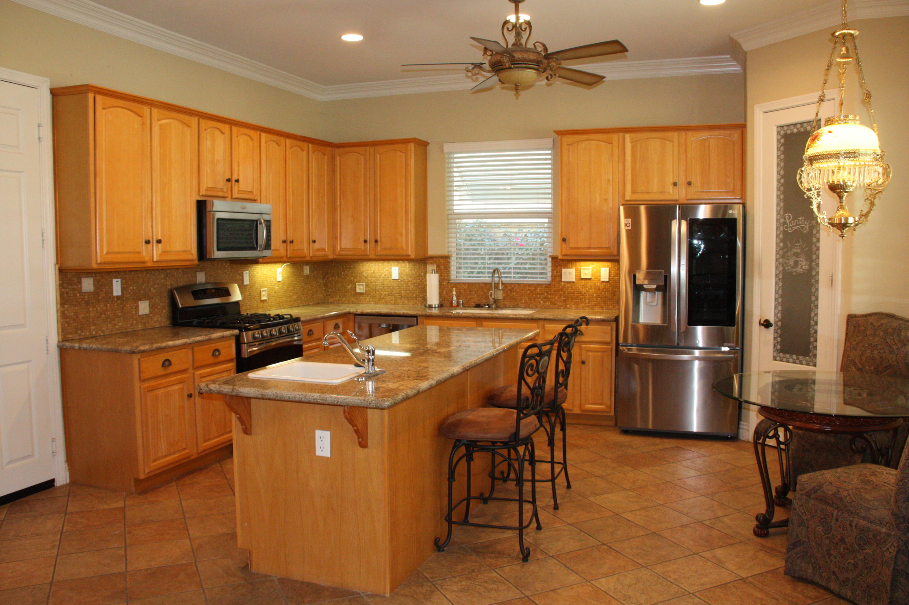 49475 Redford Way Indio, CA 92201 - Photo 23 of 58 a kitchen with stainless steel appliances granite countertop a sink stove and refrigerator