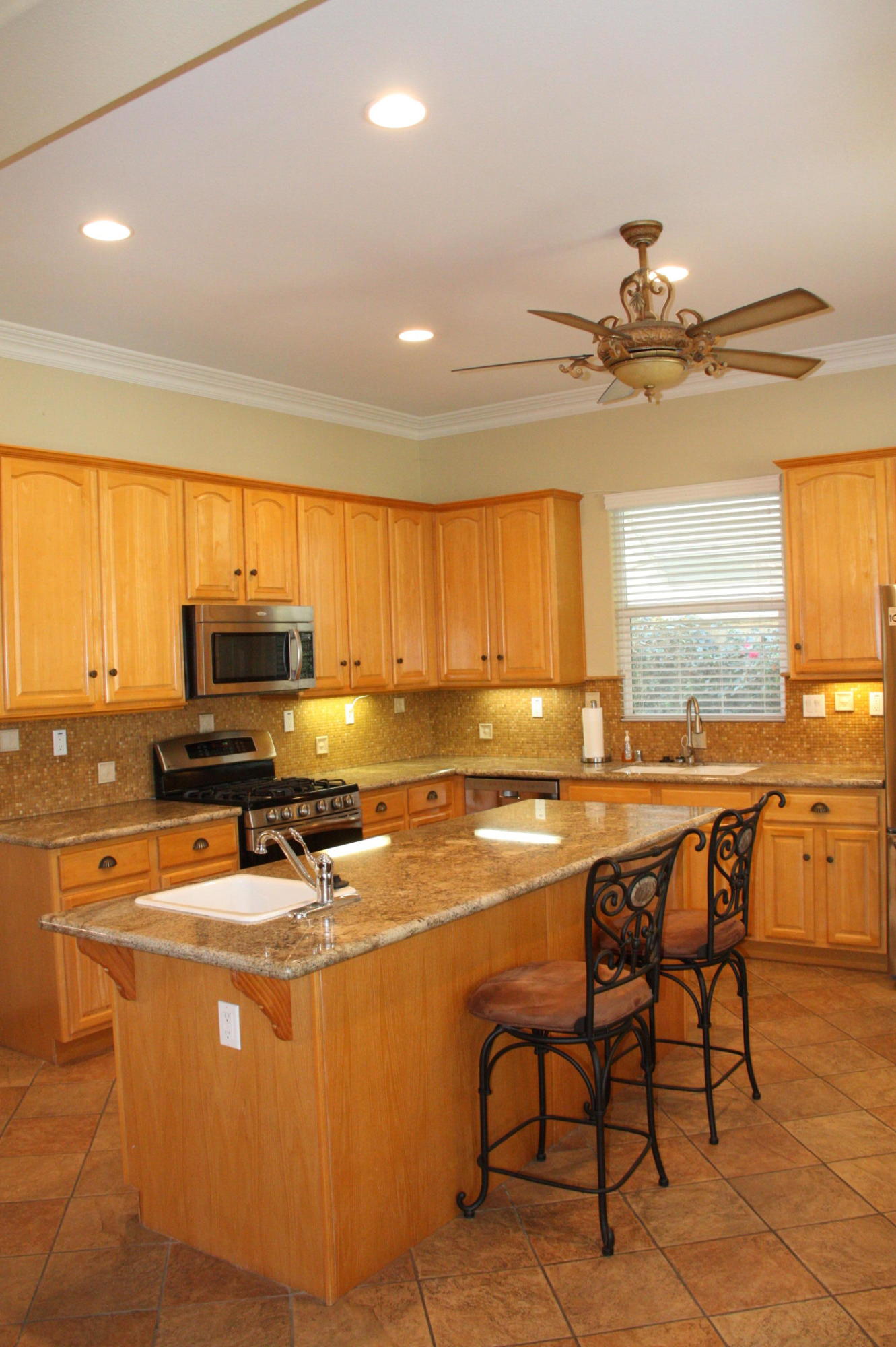 49475 Redford Way Indio, CA 92201 - Photo 24 of 58 a room with stainless steel appliances a table chairs and a refrigerator