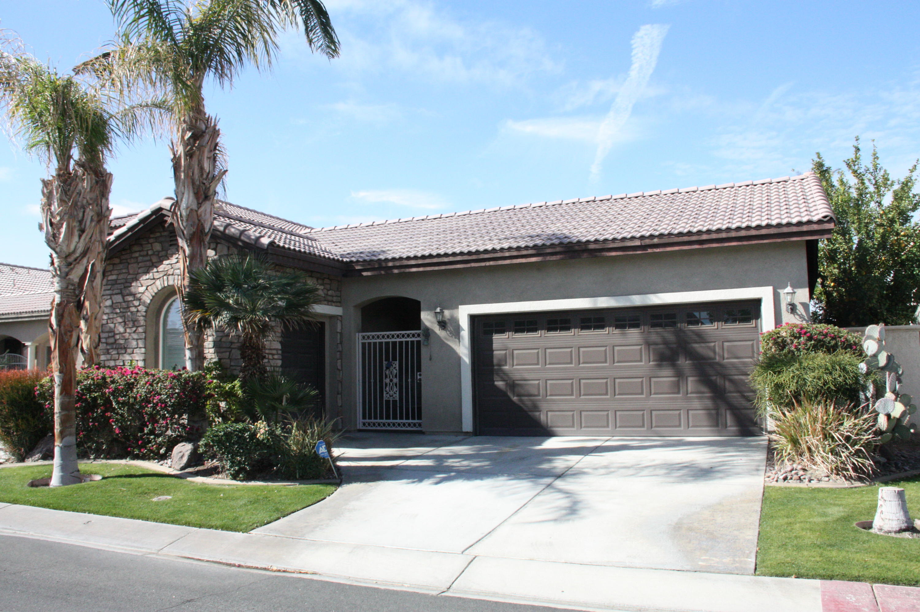 49475 Redford Way Indio, CA 92201 - Photo 5 of 58 front view of a house with a yard