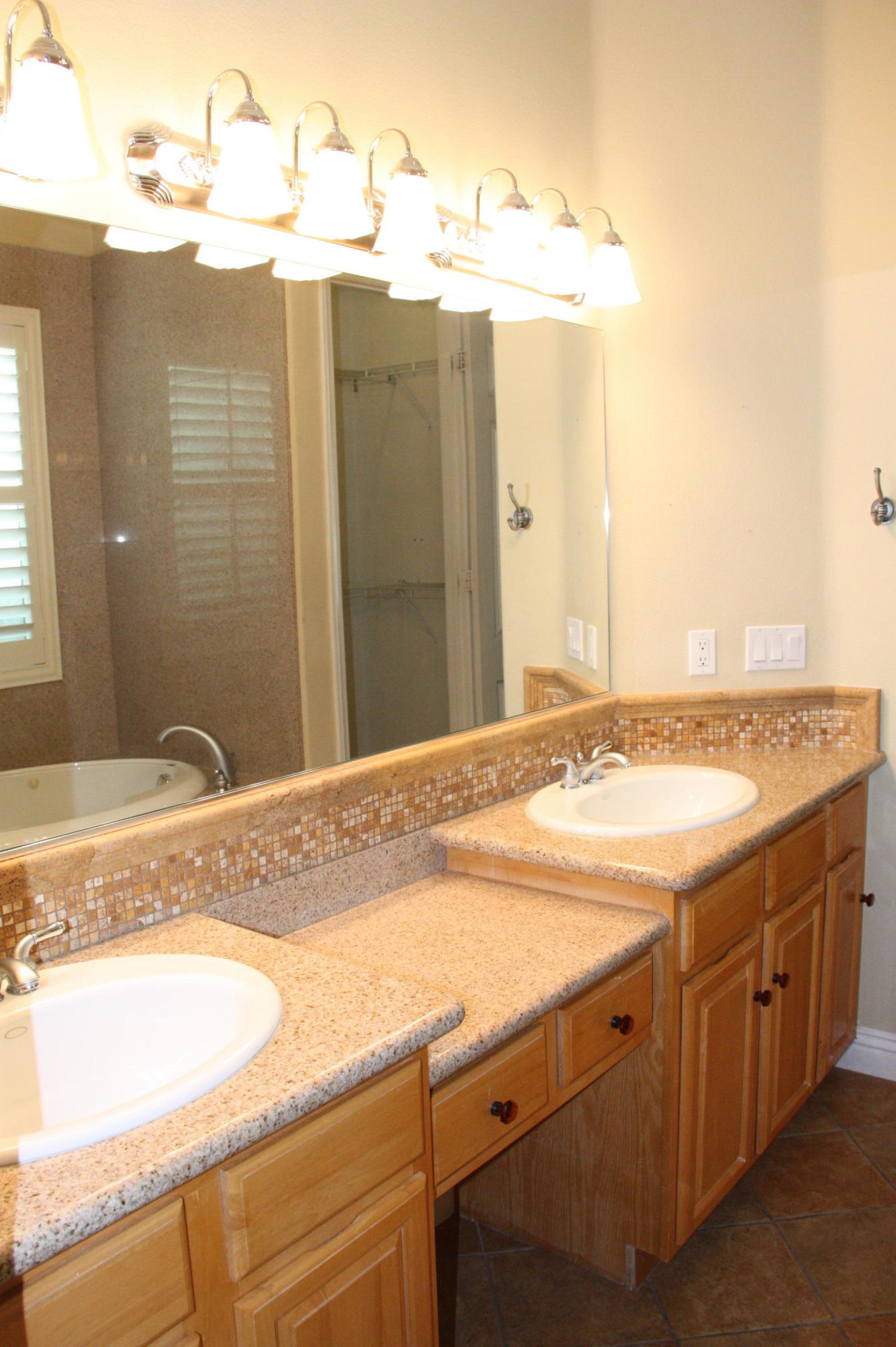 49475 Redford Way Indio, CA 92201 - Photo 41 of 58 a bathroom with a granite countertop sink and mirror