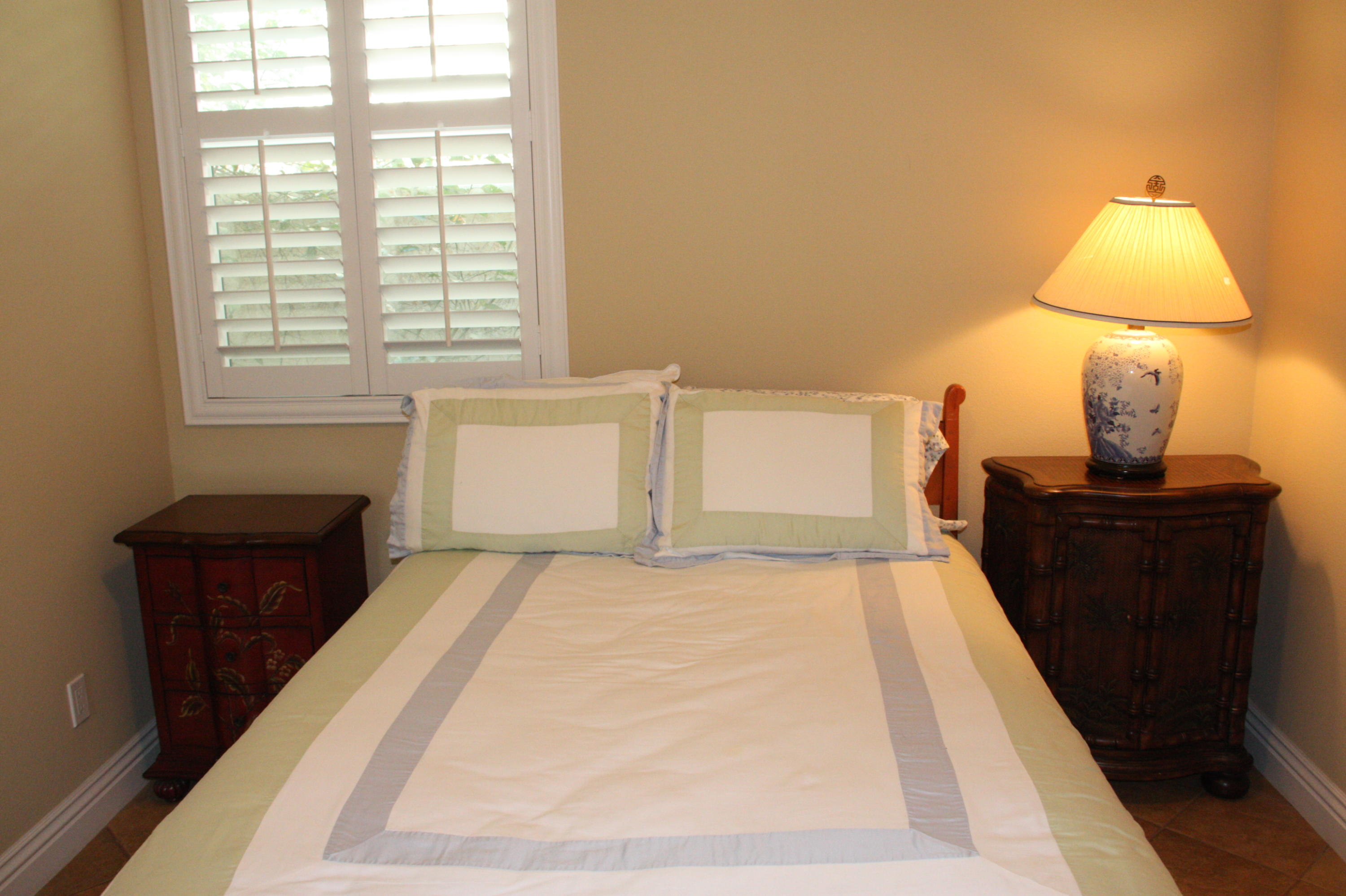 49475 Redford Way Indio, CA 92201 - Photo 49 of 58 a bedroom with a bed and a lamp