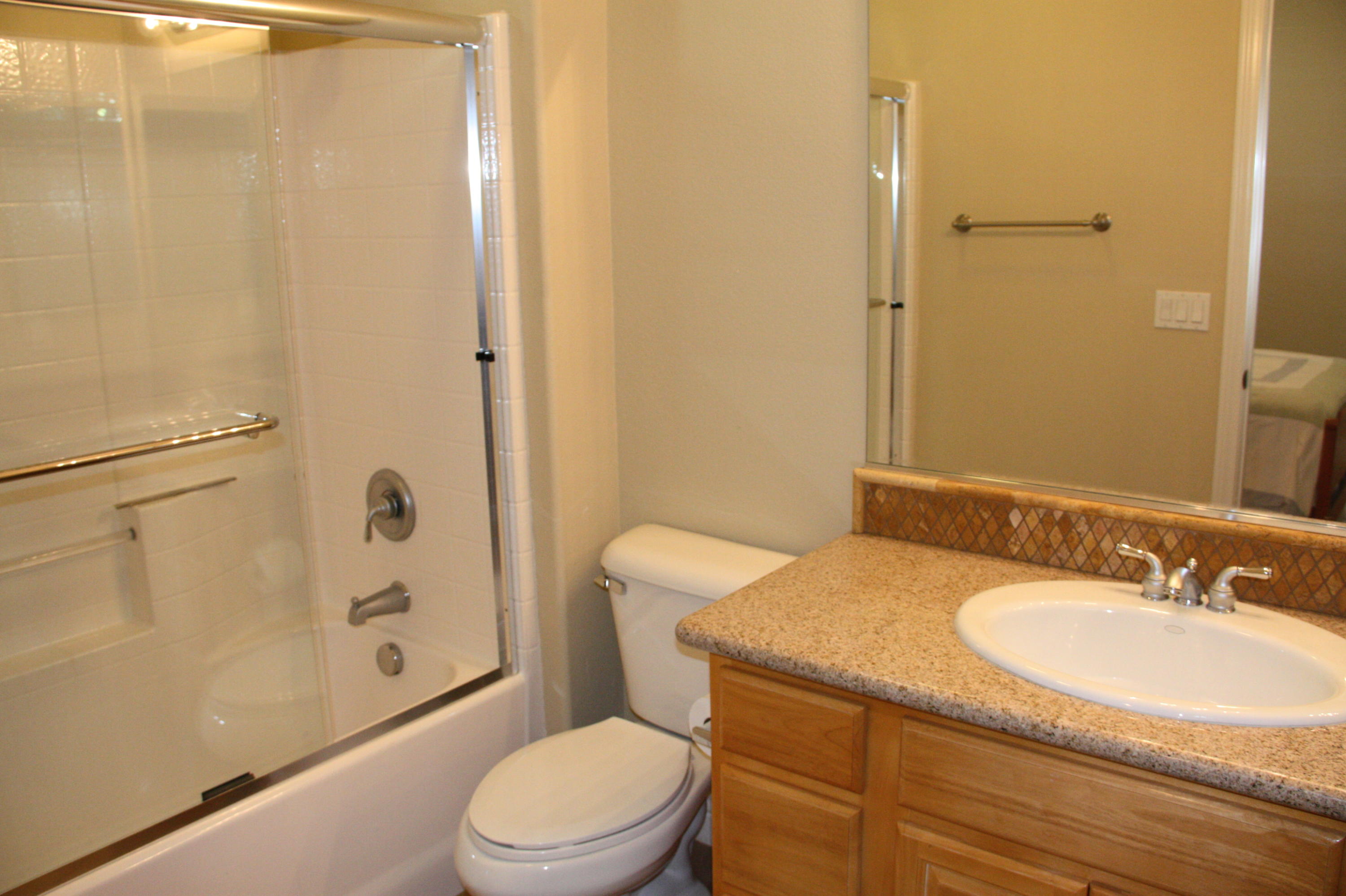 49475 Redford Way Indio, CA 92201 - Photo 52 of 58 a bathroom with a granite countertop sink toilet and shower