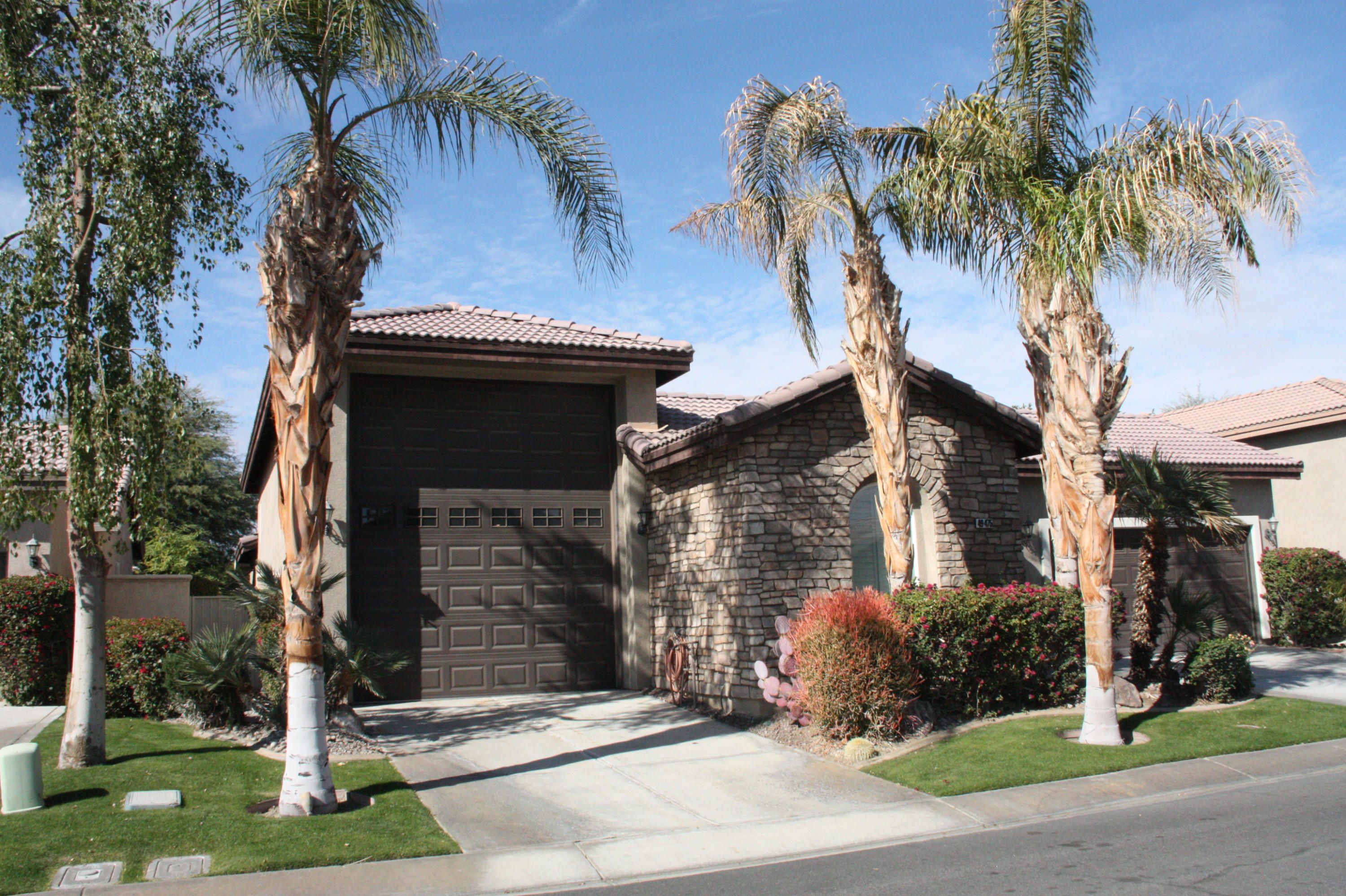 49475 Redford Way Indio, CA 92201 - Photo 7 of 58 a front view of a house with yard and parking
