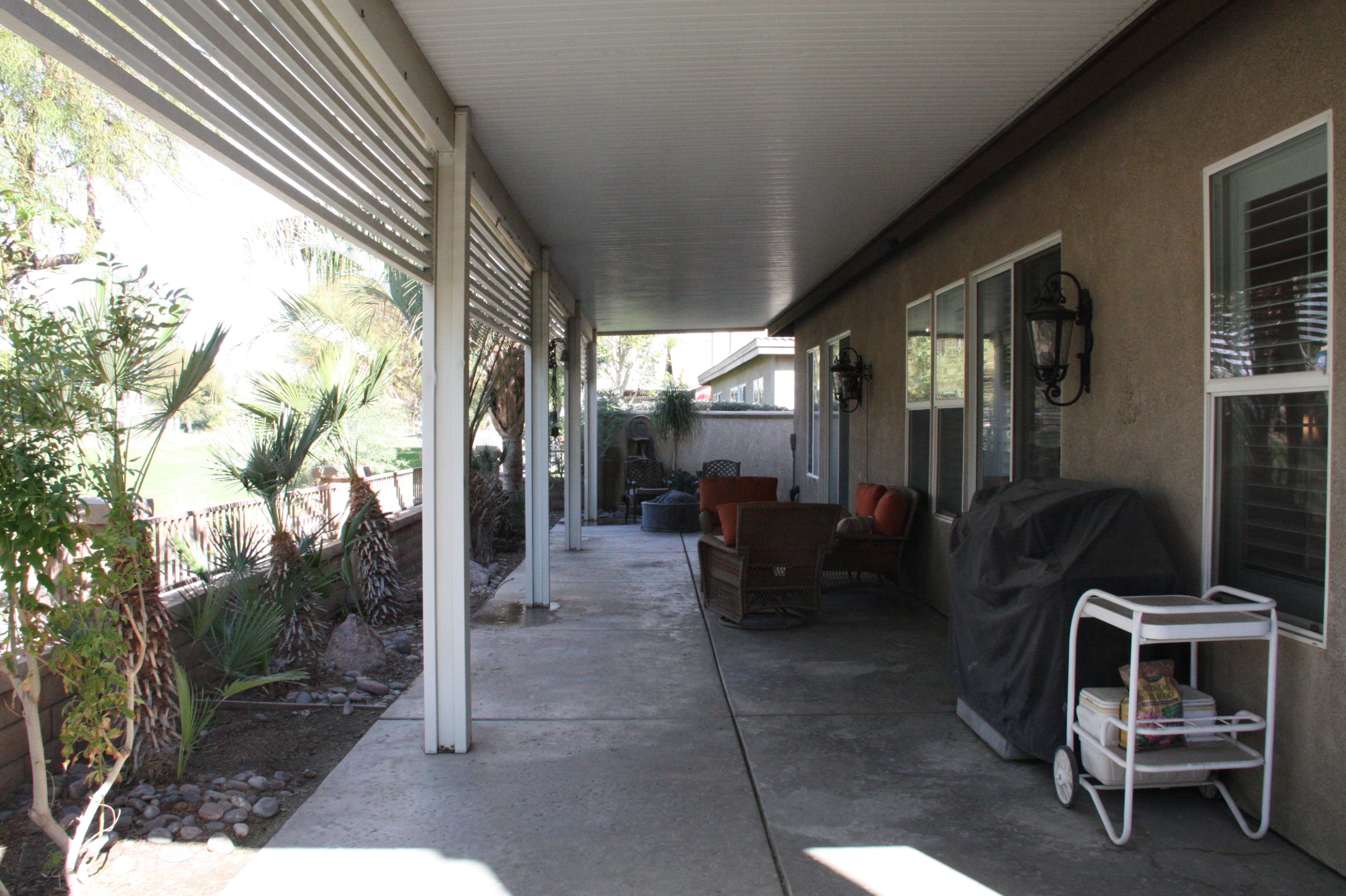 49475 Redford Way Indio, CA 92201 - Photo 10 of 58 a view of a porch with furniture and a yard