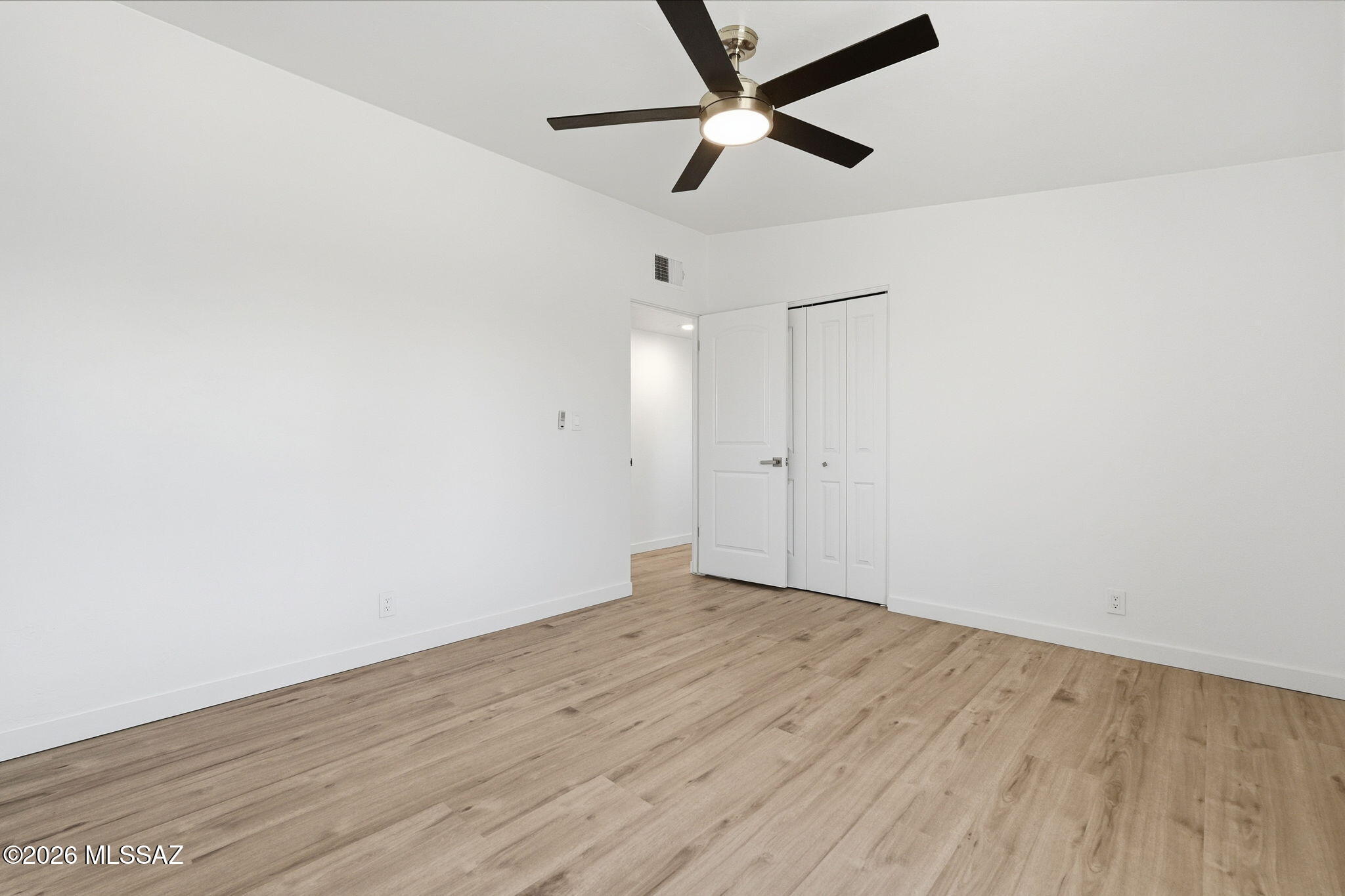 950 West Ina Road Tucson, AZ 85704 - Photo 29 of 54 an empty room with wooden floor and ceiling fan