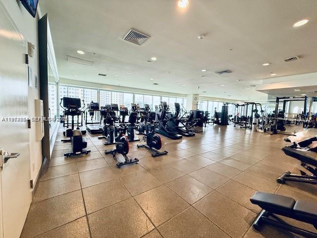 475 Brickell Avenue, Unit 4910 Miami, FL 33131 - Photo 20 of 25 a room with gym equipment and large mirror
