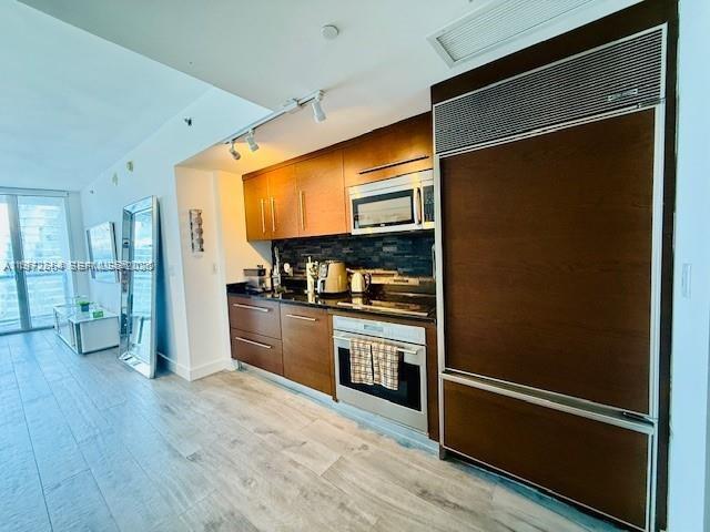 475 Brickell Avenue, Unit 4910 Miami, FL 33131 - Photo 2 of 25 a kitchen with stainless steel appliances granite countertop a refrigerator and a stove