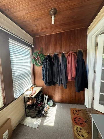 a hallway with a couch and a window