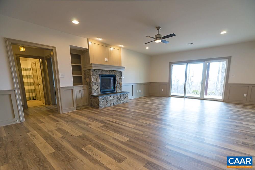 2492 Summit Ridge Trail Charlottesville, VA 22911 - Photo 41 of 50 an empty room with wooden floor fireplace and windows