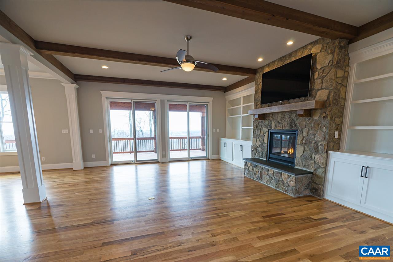 2492 Summit Ridge Trail Charlottesville, VA 22911 - Photo 7 of 50 a view of a livingroom with fireplace wooden floor and flat screen tv