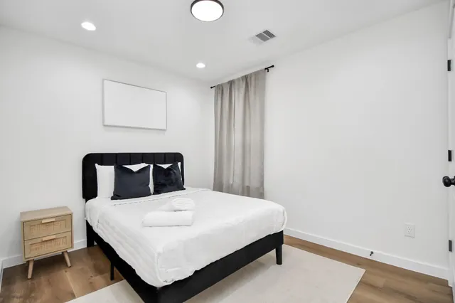 a bedroom with a bed and a night stand