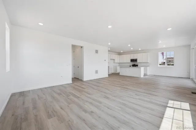 a view of kitchen with a sink and a refrigerator