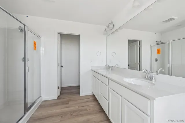 a bathroom with a double vanity sink and a mirror