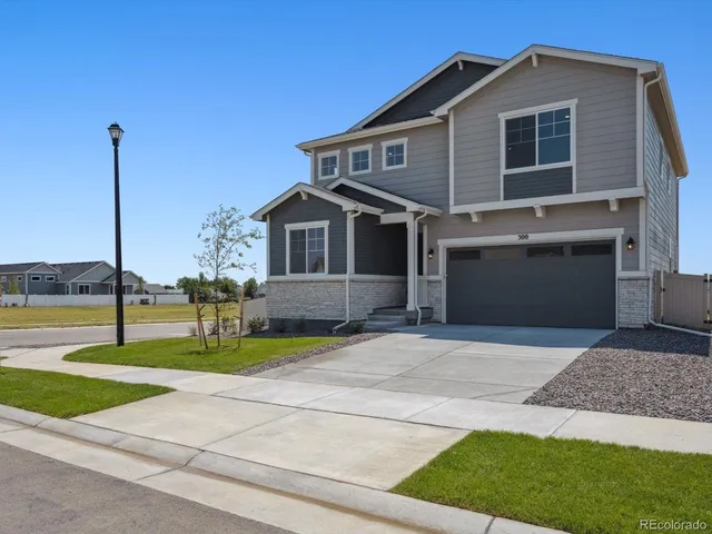 a front view of a house with garden and patio