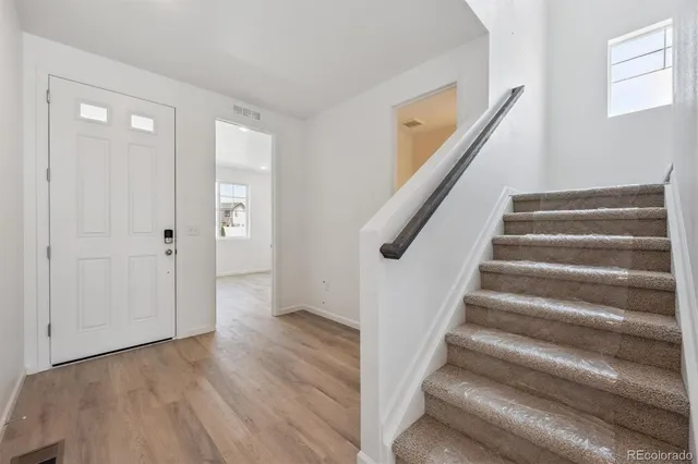 a view of an entryway with wooden floor