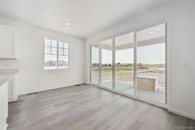 an empty room with large windows