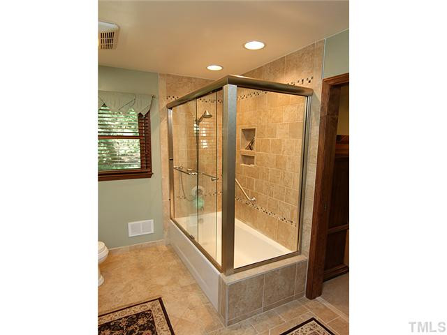 8829 Woodyhill Road Raleigh, NC 27613 - Photo 4 of 21 Very easy to use master shower/tub. Good attention to detail in this renovation. Master Bath/Spa