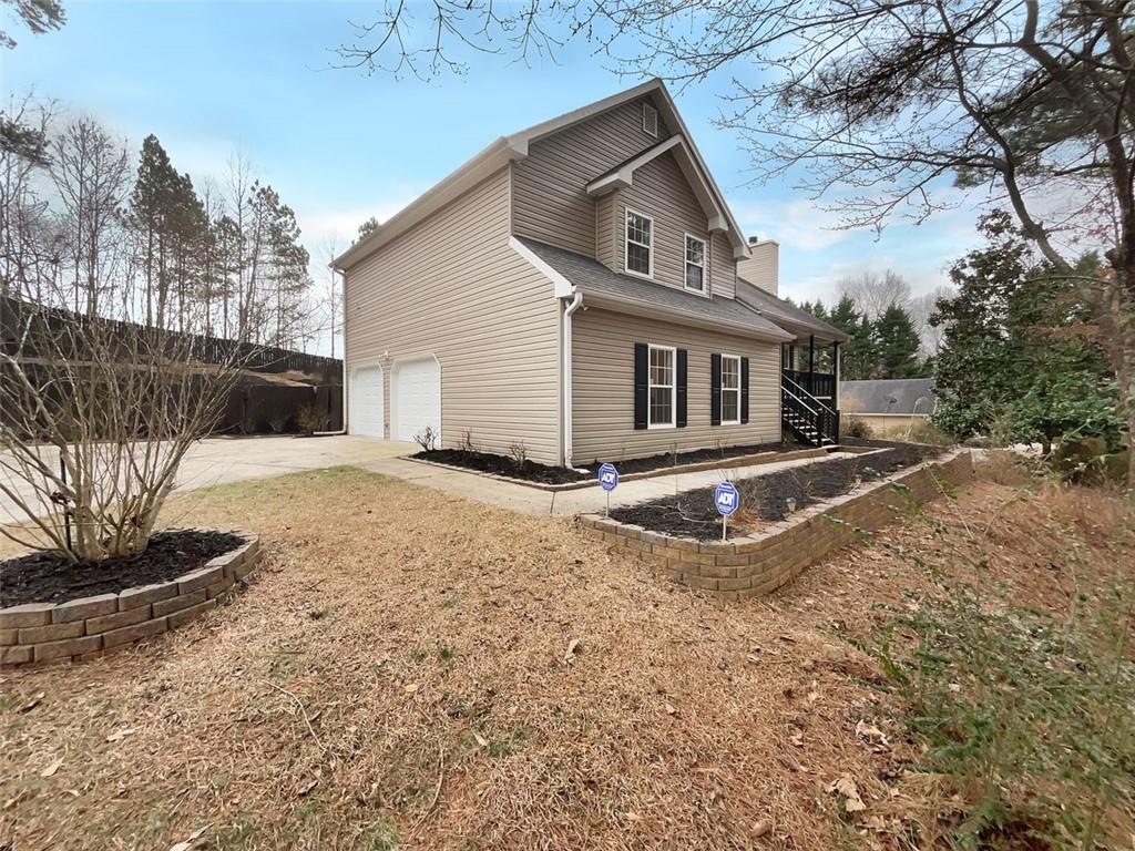 6785 Payton Road Cumming, GA 30041 - Photo 1 of 1 a front view of a house with a yard