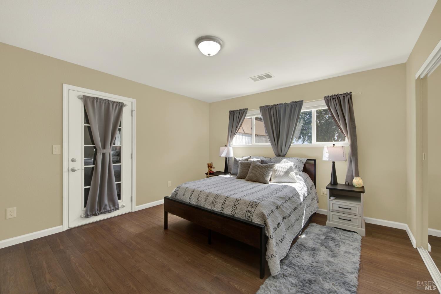 4851 Udell Road Vacaville, CA 95688 - Photo 20 of 65 a bedroom with a bed and a large mirror