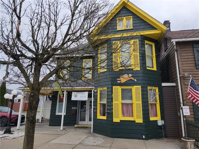 a front view of a residential apartment building with a yard