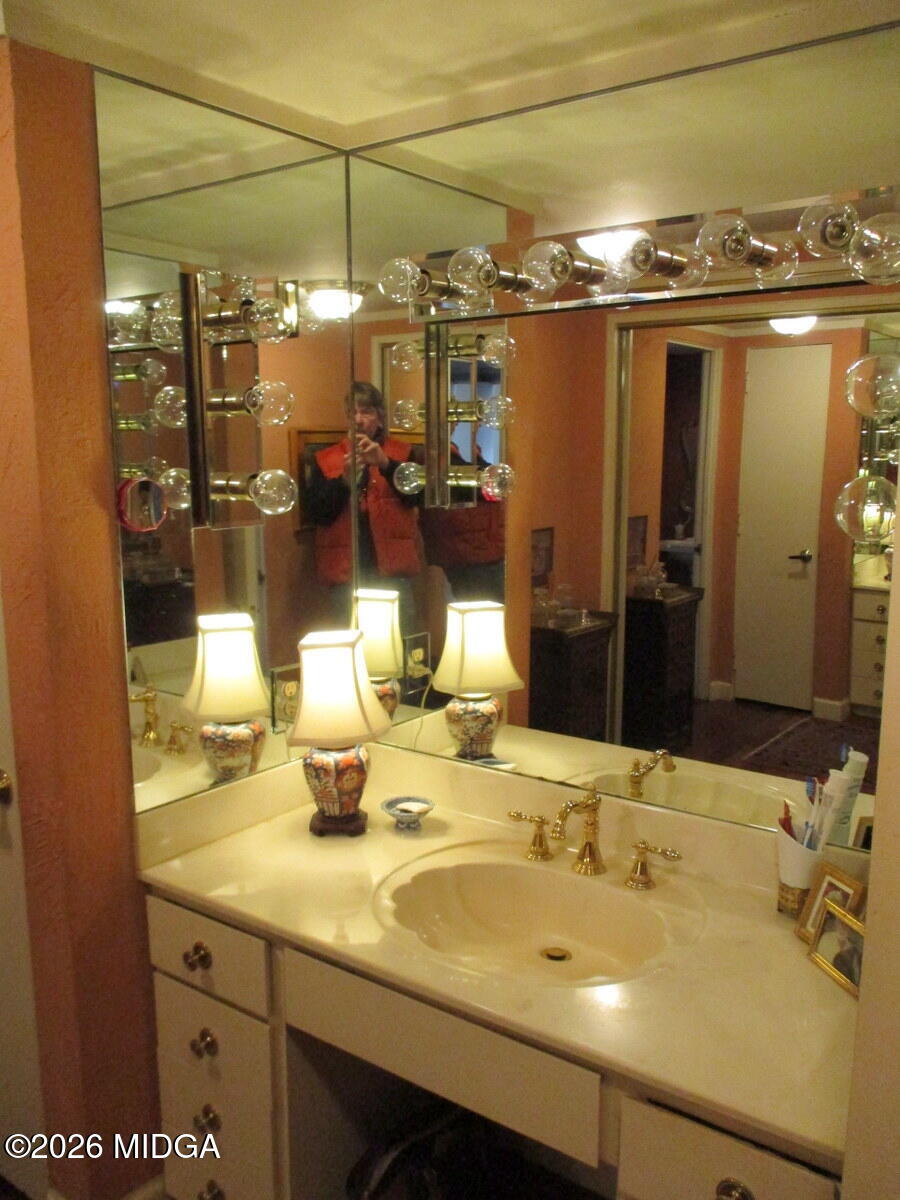 1121 South Jackson Springs Road Macon, GA 31211 - Photo 22 of 29 a bathroom with a sink and mirror