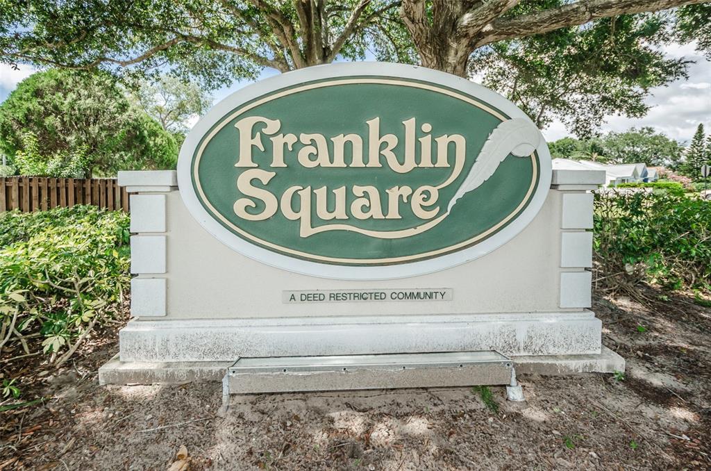 1481 Cairn Court Palm Harbor, FL 34683 - Photo 35 of 40 with sign on top of a wooden fence