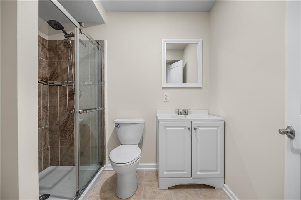 203 Ledge Rock Lane Mars, PA 16046 - Photo 22 of 33 a bathroom with a toilet sink and shower