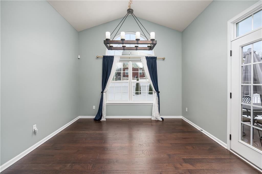 203 Ledge Rock Lane Mars, PA 16046 - Photo 7 of 33 an empty room with wooden floor staircase and a chandelier