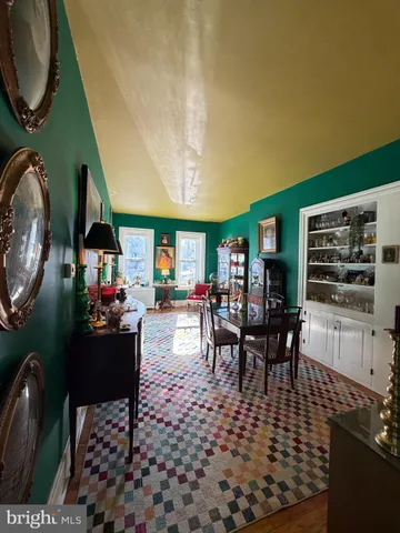 a dining room with furniture and wooden floor