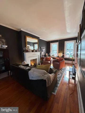 a living room with furniture fireplace and window