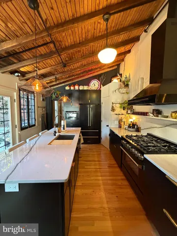 a kitchen with stainless steel appliances a stove a sink and a refrigerator