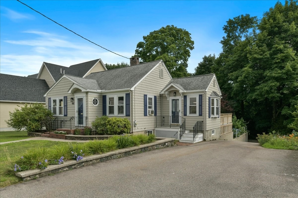 102 Border Street Dedham, MA 02026 - Photo 1 of 34 a view of a white house with a yard and plants
