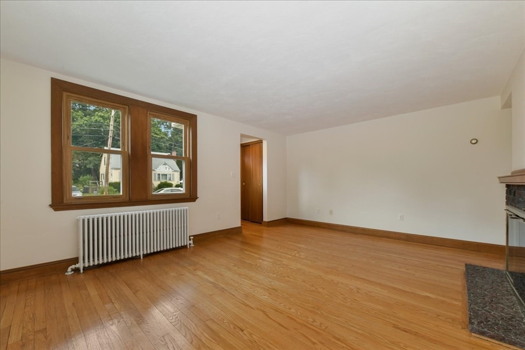 102 Border Street Dedham, MA 02026 - Photo 17 of 34 an empty room with wooden floor and windows