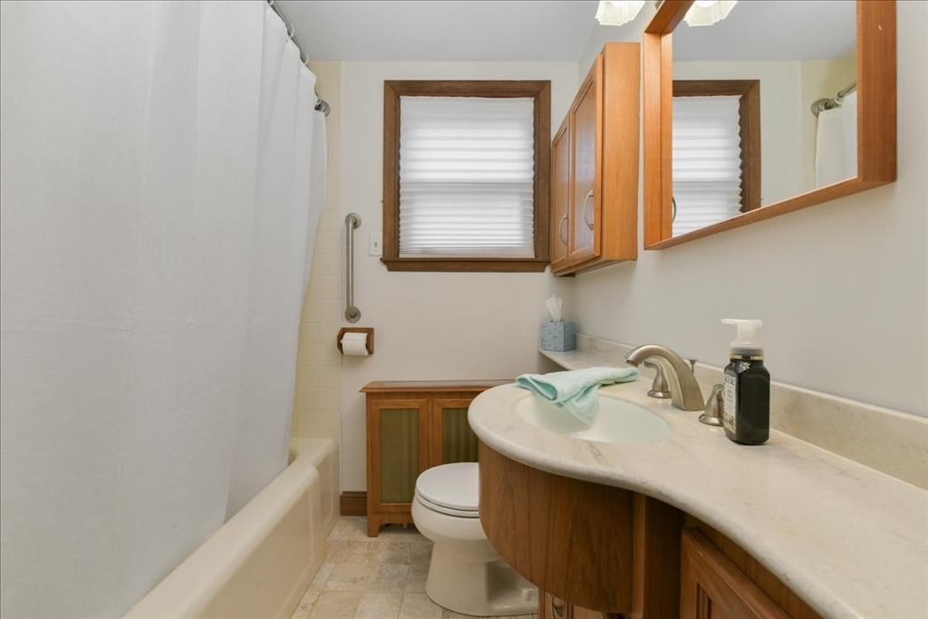 102 Border Street Dedham, MA 02026 - Photo 6 of 34 a bathroom with a toilet a sink and mirror