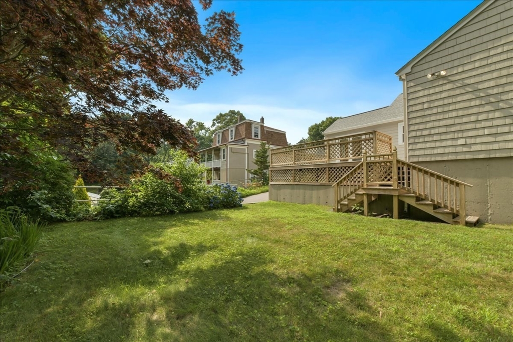102 Border Street Dedham, MA 02026 - Photo 7 of 34 a view of a big yard with large buildings and a big yard