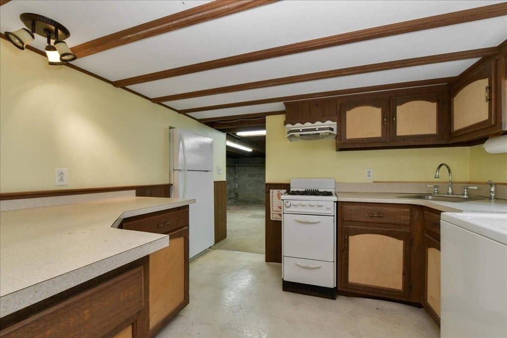 102 Border Street Dedham, MA 02026 - Photo 10 of 34 a kitchen with stainless steel appliances granite countertop a sink and a stove