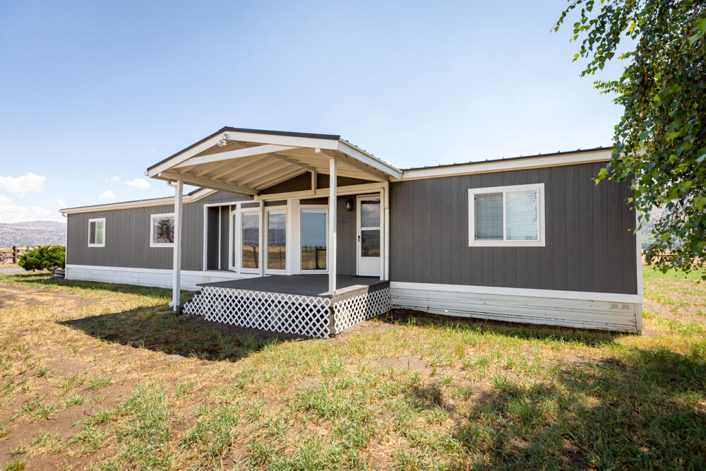 8757 Reeder Road Klamath Falls, OR 97603 - Photo 2 of 34 a front view of a house with a garden