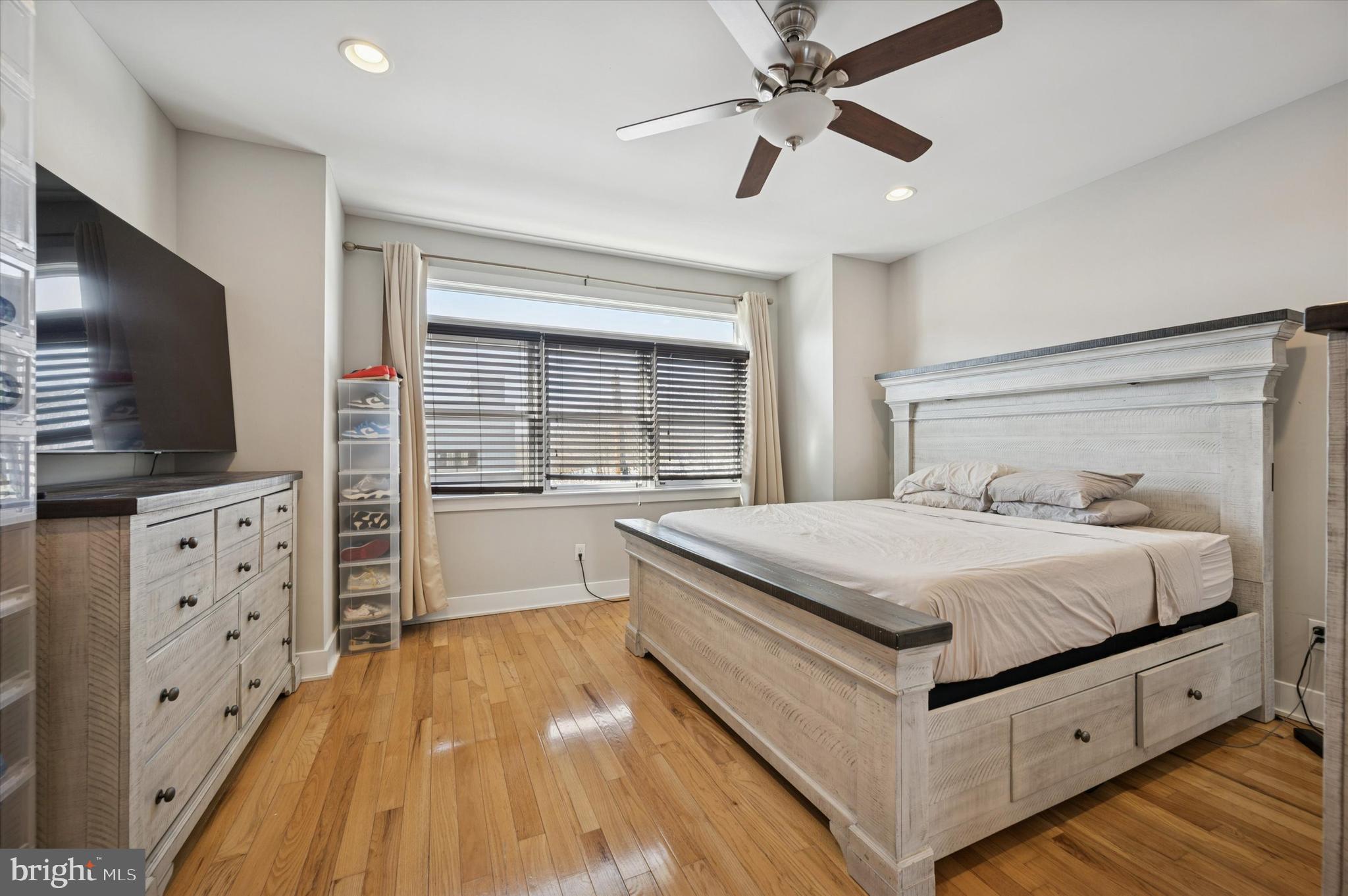 4743 Sheldon Street Philadelphia, PA 19127 - Photo 18 of 18 a spacious bedroom with a large bed and flat tv screen on dresser